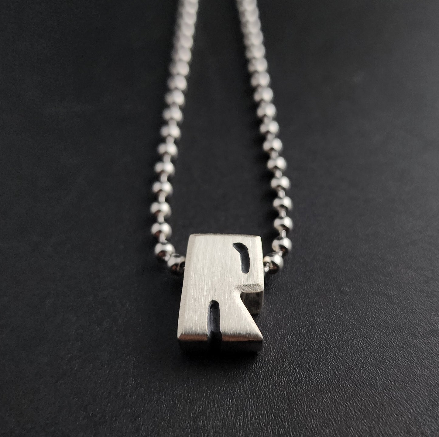 R (silver)