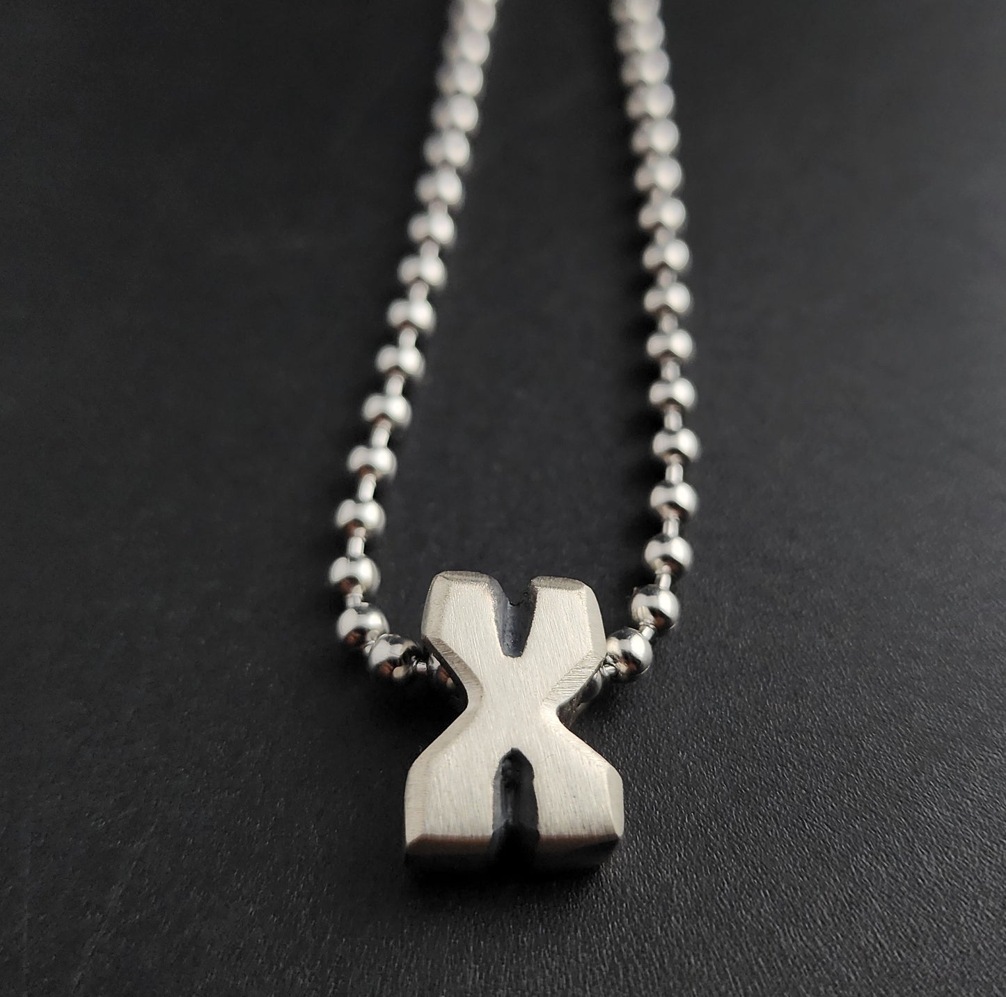 X (silver)