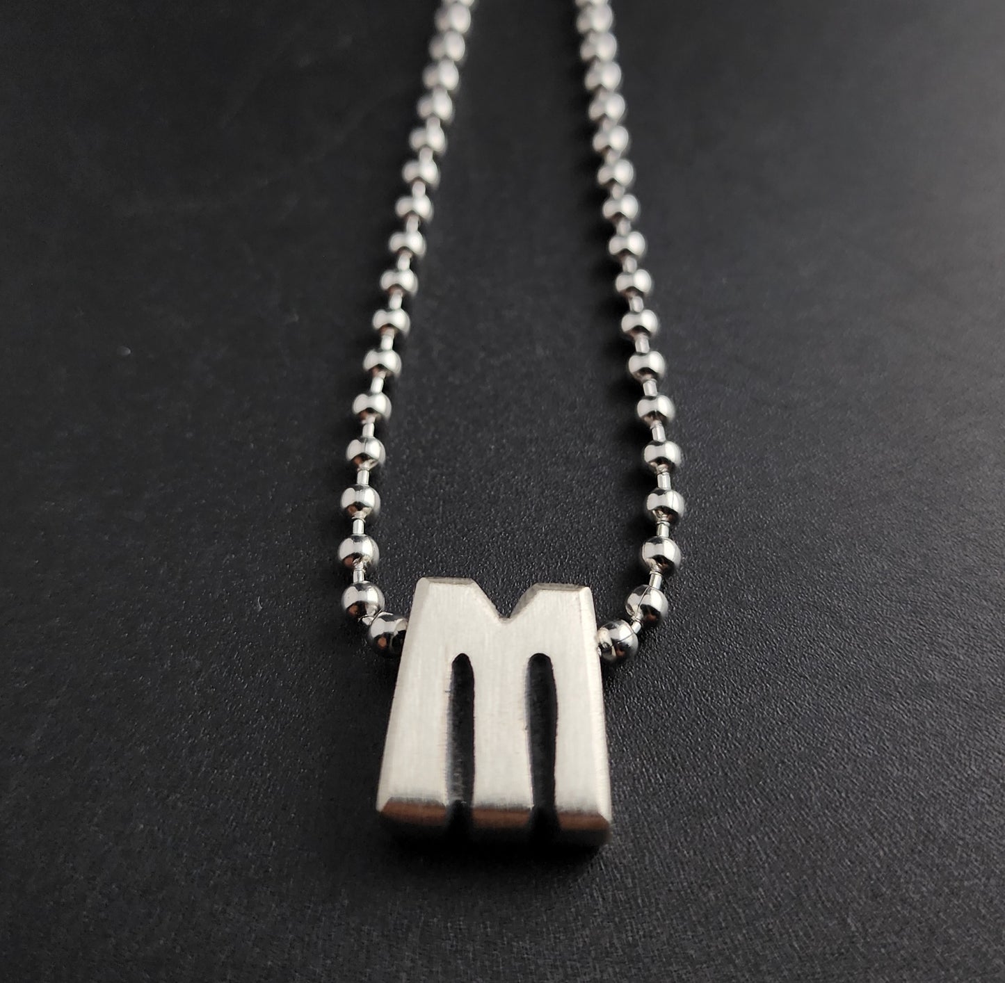 M (silver)